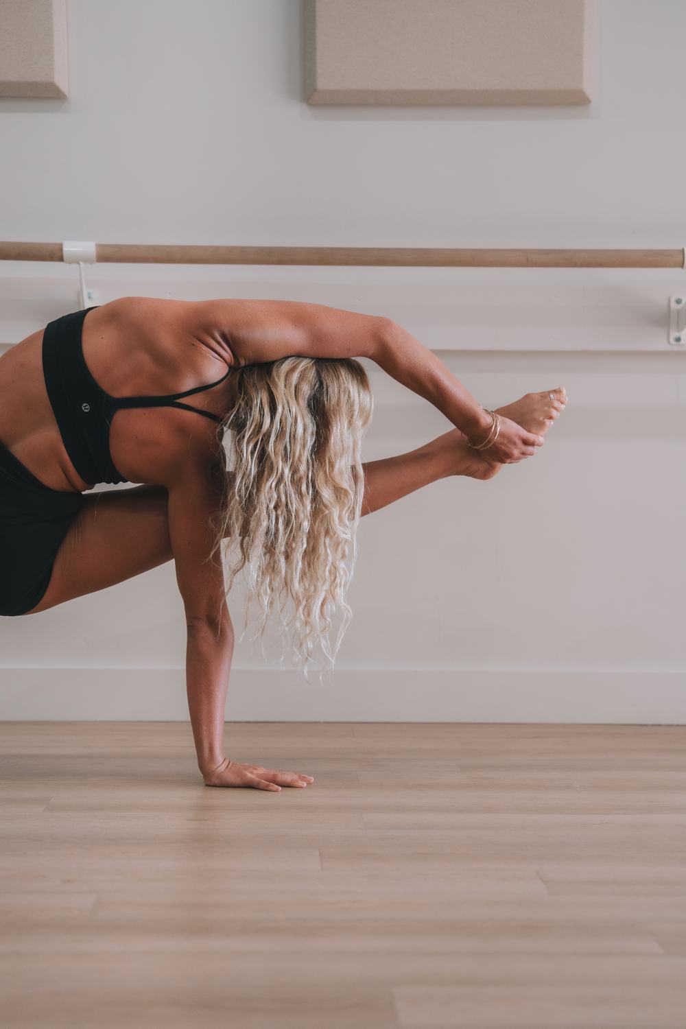 Macy in a balance pose by the barre